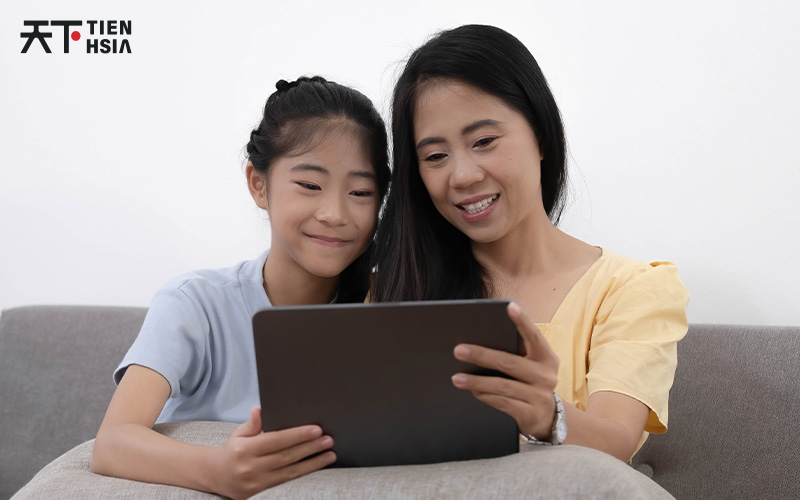 Happy family on the couch looking at the tablet