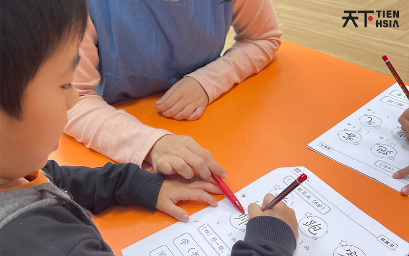 Teacher guiding young students in a learning session