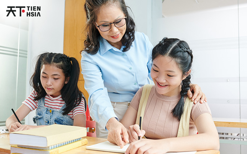 Teacher guiding two students