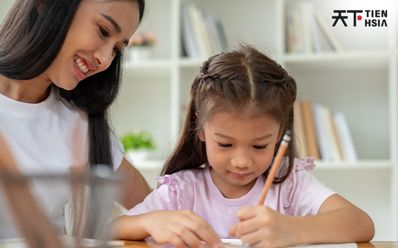Mother helping child with homework, considering enrichment classes.