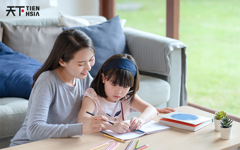 Tutor assisting child with Upper Primary Chinese studies