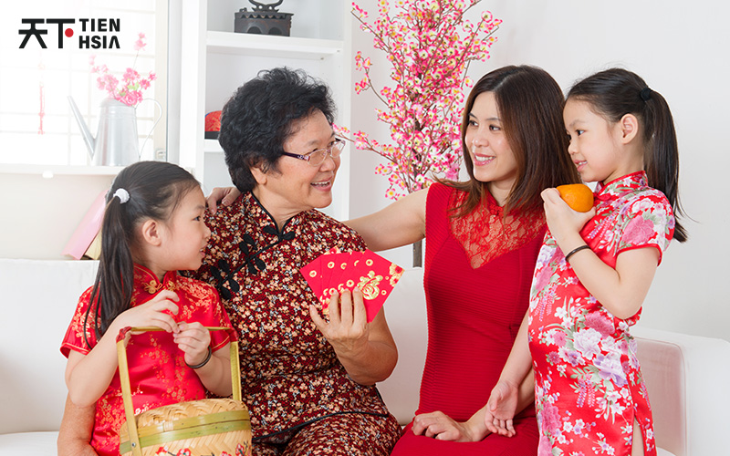 Family celebrating Chinese New Year with red packets.
