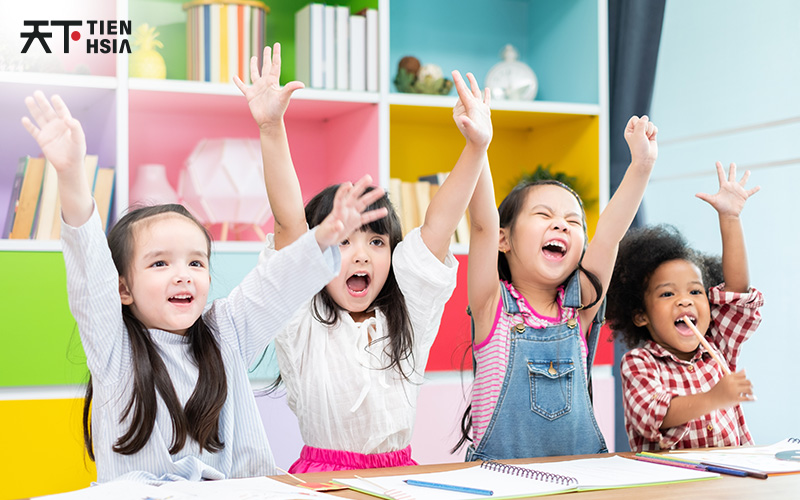 Happy preschool students learning Chinese with enthusiasm.