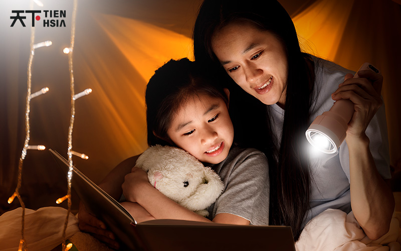 Mother and daughter reading a book about Chinese folktales.