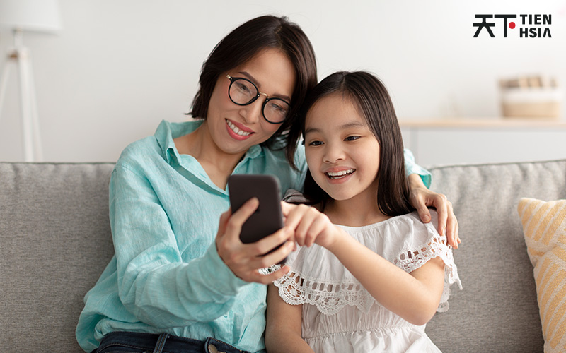 Mother and daughter using a mobile app for Chinese.