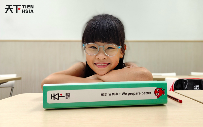 Preschool kid smiling during Chinese class